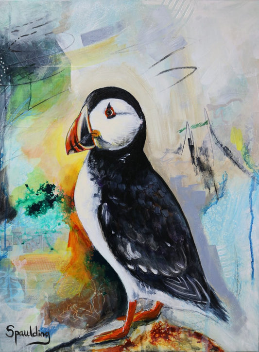 A puffin stands profiled with bold black and white plumage against a light, abstract backdrop.
