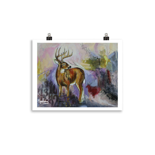 Paper art print of a whitetail deer standing with antlers and a background of pinks, yellows,purples, deep reds and black.