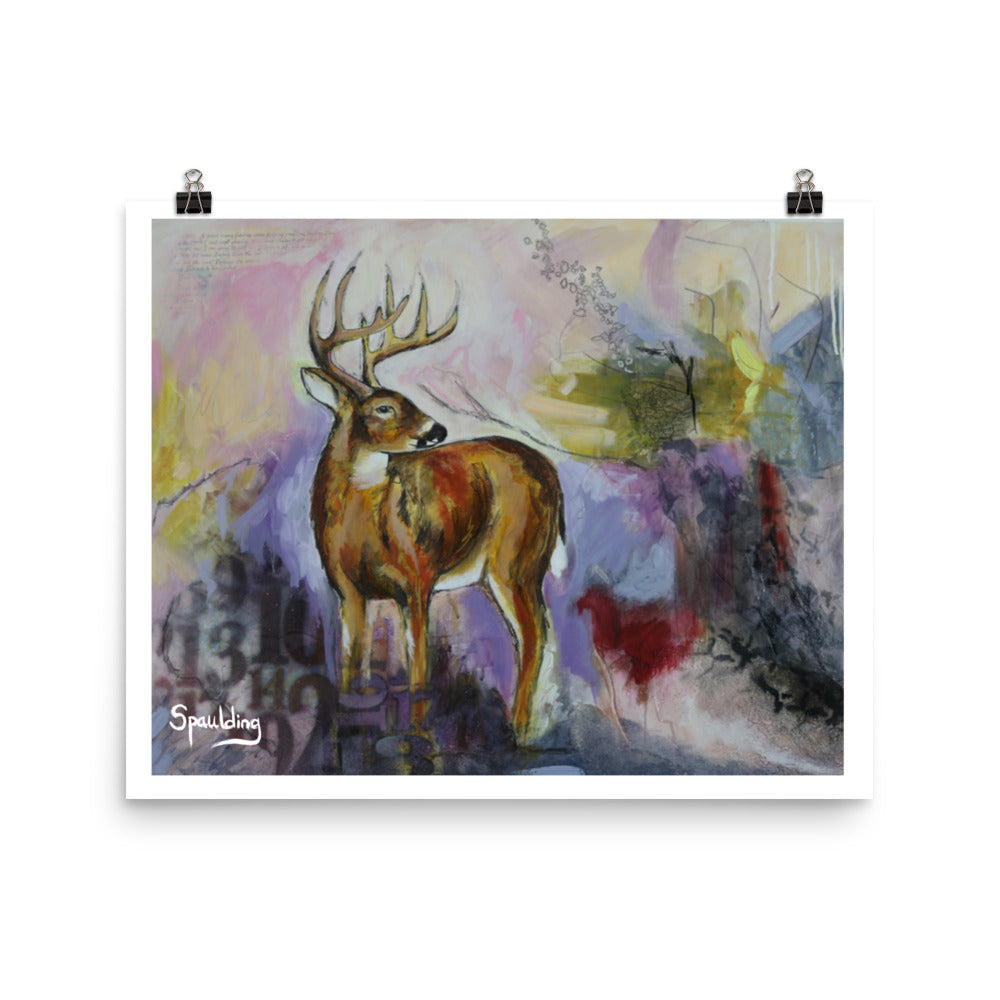 Paper art print of a whitetail deer standing with antlers and a background of pinks, yellows,purples, deep reds and black.