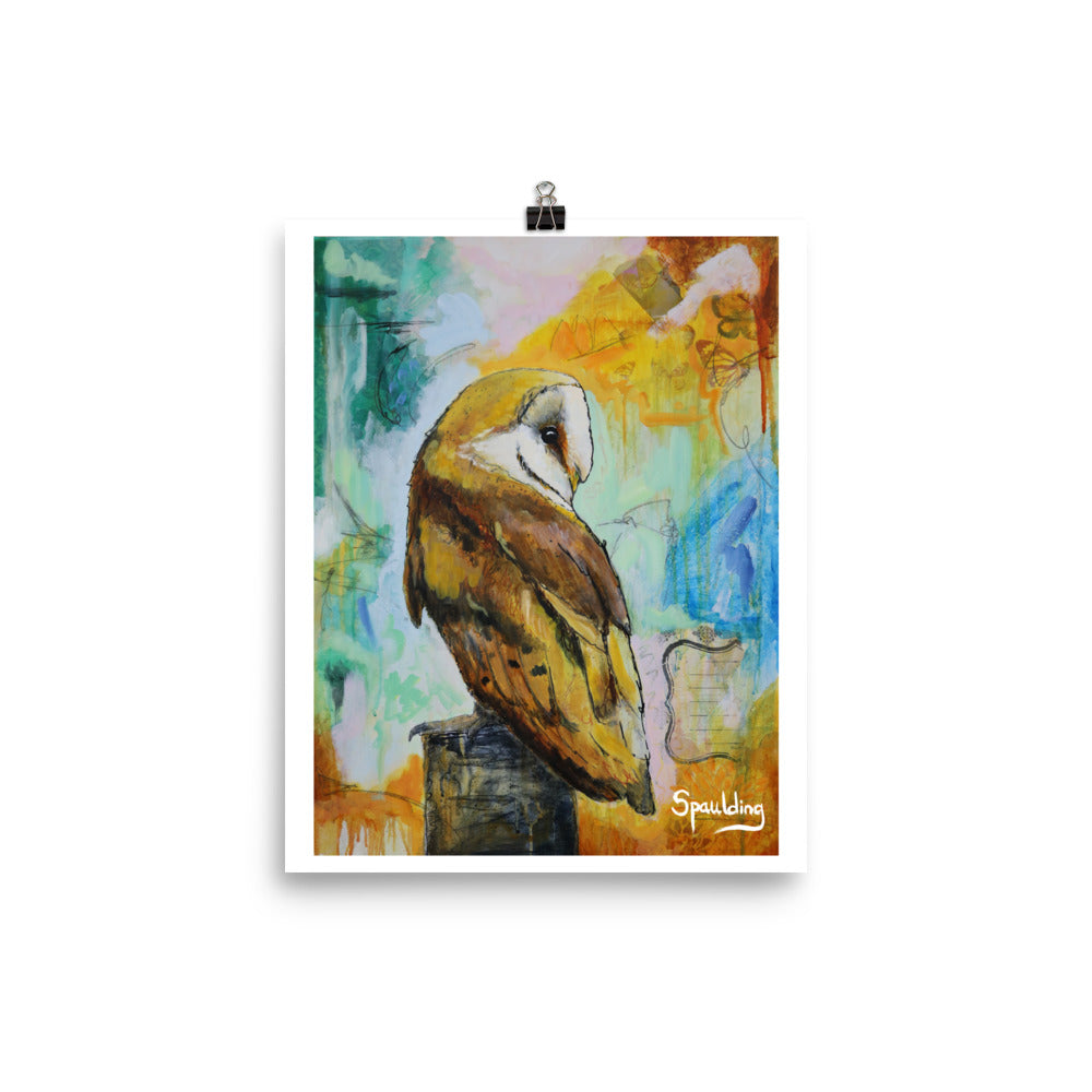 Paper art print of a barn owl on a tree stump with teals, pinks, oranges and blue in the background.