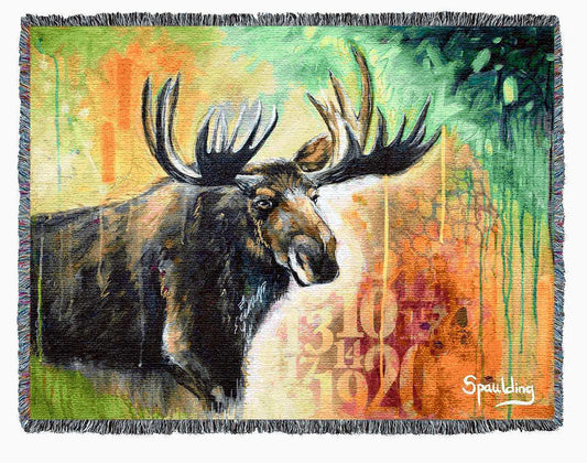 Moose with antlers, yellow, orange, reds, and greens color scheme woven throw blanket: Nature-inspired comfort for wildlife enthusiasts.