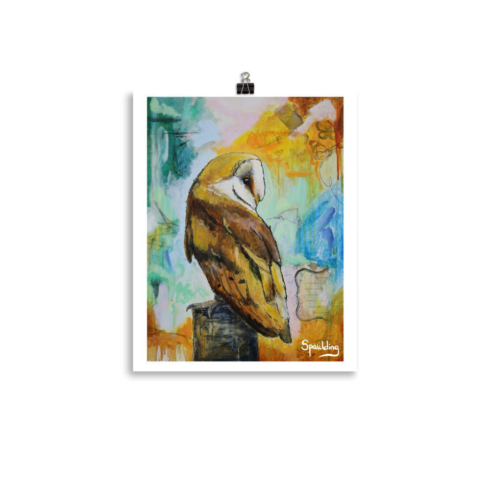Paper art print of a barn owl on a tree stump with teals, pinks, oranges and blue in the background.
