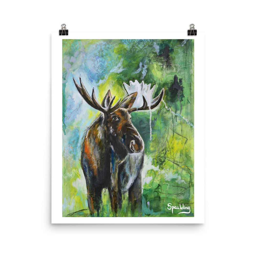 Paper art print of a bull moose with antlers standing in front of a background of, blues, greens and yellow.