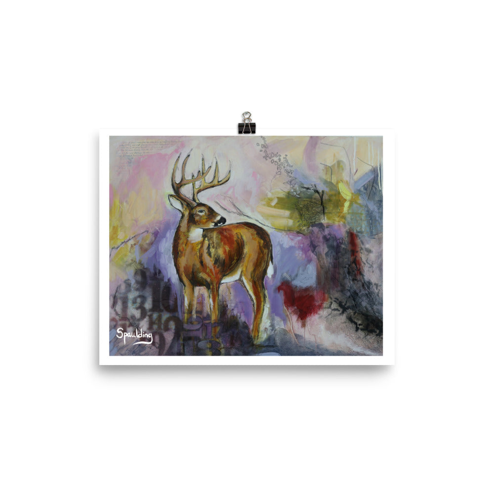 Paper art print of a whitetail deer standing with antlers and a background of pinks, yellows,purples, deep reds and black.